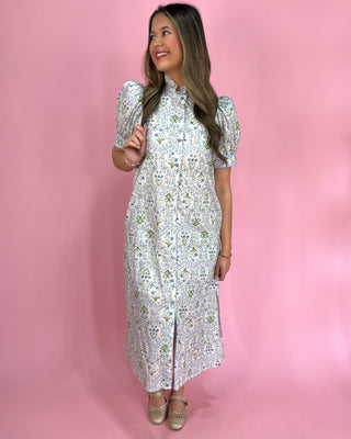 Woman wearing a floral dress against a pink background