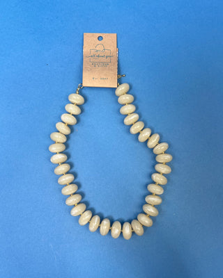Chunky marbled resin bead statement necklace with oversized cream beads, gold-tone spacer accents, adjustable clasp closure, and lightweight design, available in multiple colors.