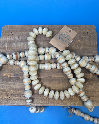 Chunky marbled resin bead statement necklace with oversized cream beads, gold-tone spacer accents, adjustable clasp closure, and lightweight design, available in multiple colors.