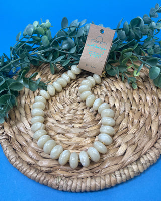 Chunky marbled resin bead statement necklace with oversized cream beads, gold-tone spacer accents, adjustable clasp closure, and lightweight design, available in multiple colors.
