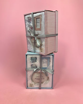 Two gift boxes with ribbons on a pink background