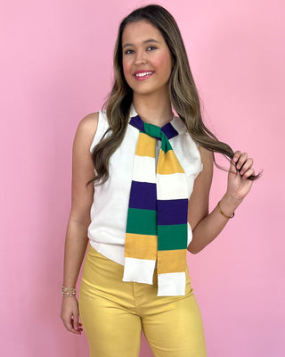 Woman wearing a colorful scarf with a pink background