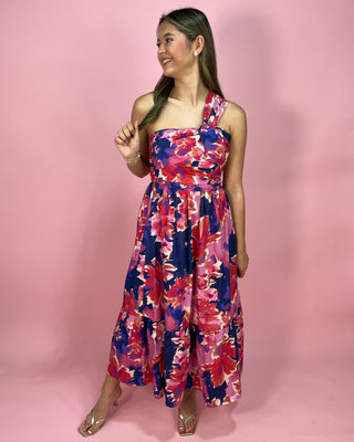 Woman wearing a floral dress against a pink background