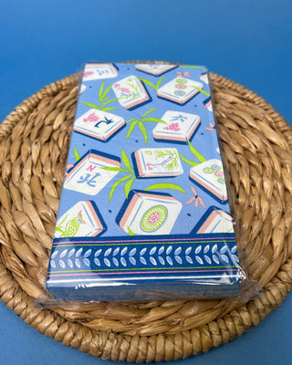 Package of Mahjong Guest Napkins featuring colorful Mahjong tile illustrations with bamboo leaves on a soft blue background. Premium 3-ply paper guest towels for entertaining and game nights.