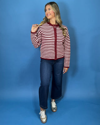 Burgundy and ivory striped button-front knit cardigan with long sleeves, contrast trim, and a relaxed fit.