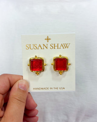 Red square earrings with gold accents on a 'Susan Shaw' card.