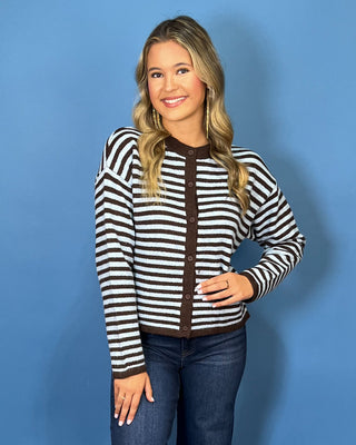 Light blue and chocolate brown striped button-front knit cardigan with long sleeves, contrast trim, and a relaxed fit.
