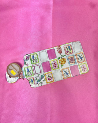 Mahjong charcuterie board with coordinating spreader featuring colorful Mahjong tile artwork and cork backing for serving cheese, appetizers, and snacks during game nights and entertaining.