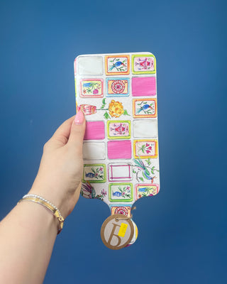 Mahjong charcuterie board with coordinating spreader featuring colorful Mahjong tile artwork and cork backing for serving cheese, appetizers, and snacks during game nights and entertaining.