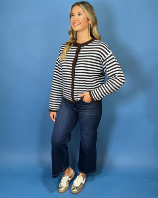Light blue and chocolate brown striped button-front knit cardigan with long sleeves, contrast trim, and a relaxed fit.