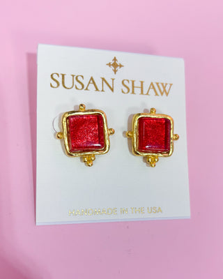 Red square earrings with gold accents on a Susan Shaw branded card against a pink background
