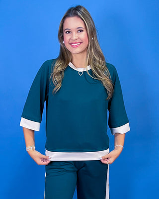 two-piece tracksuit with white contrast trim, featuring a short-sleeve top and matching wide-leg pants,