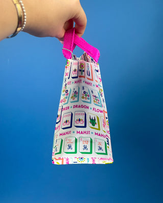 Mahjong Reusable Bag with colorful Mahjong tile print and bright pink handles, foldable reusable shopping tote for errands, gifts, and game nights.
