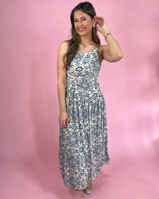 Woman wearing a floral dress against a pink background