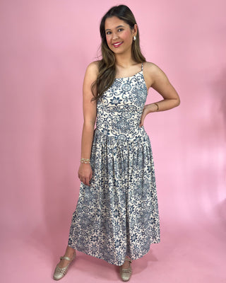 Woman wearing a floral dress against a pink background