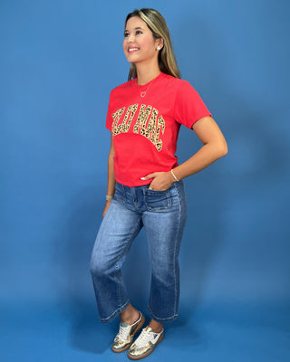 a red graphic t-shirt with leopard print lettering that reads 'LULU MAC"