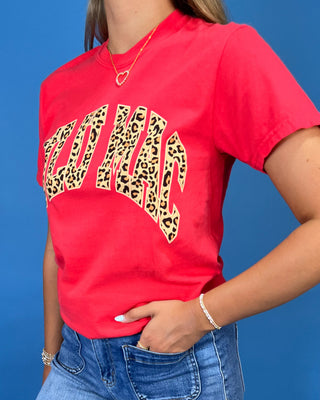 a red graphic t-shirt with leopard print lettering that reads 'LULU MAC"