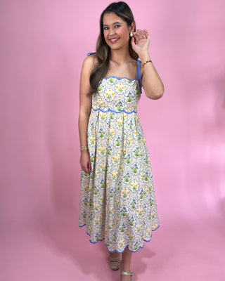 Woman wearing a floral dress against a pink background