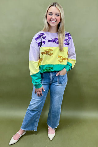 Woman wearing a colorful sweater with a green background
