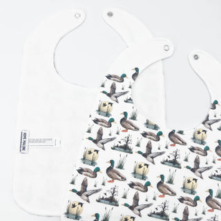 Baby bib with duck pattern on a white background