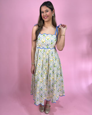 Woman wearing a floral dress against a pink background