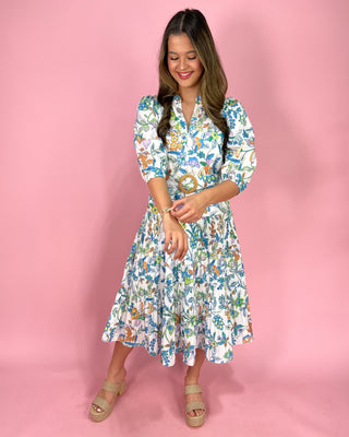 Woman wearing a floral dress against a pink background