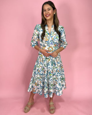 Woman wearing a floral dress against a pink background