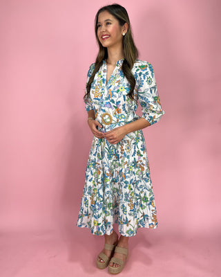 Woman wearing a floral dress against a pink background