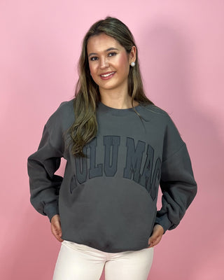 Woman wearing a gray sweatshirt with 'Gulu Mao' text on a pink background
