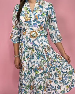 Woman wearing a floral dress with a pink background
