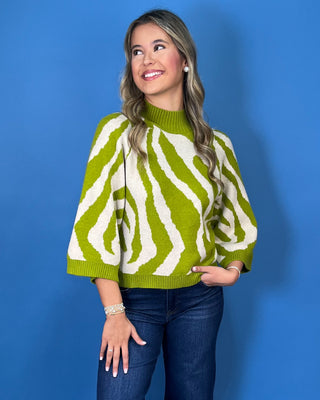 Lime green and ivory zebra print sweater with mock neckline, three-quarter sleeves, and relaxed fit.