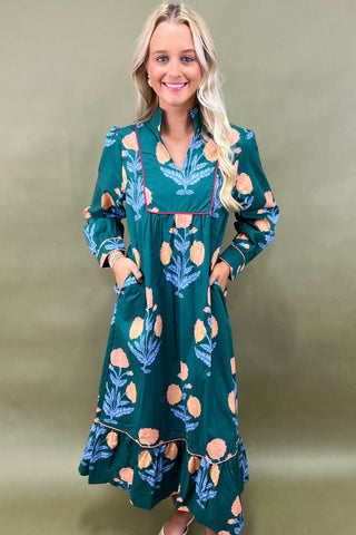 Woman wearing a green floral dress against a green background
