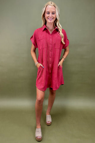 Woman wearing a red dress against a green background