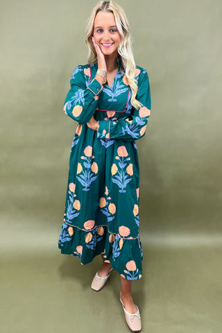 Woman wearing a green floral dress against a green background