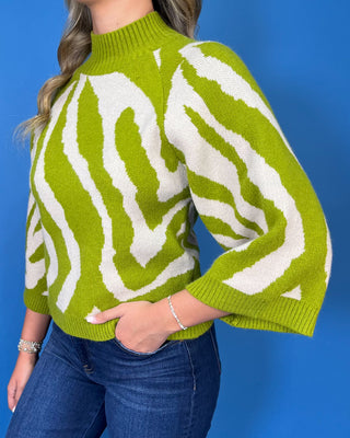 Lime green and ivory zebra print sweater with mock neckline, three-quarter sleeves, and relaxed fit.