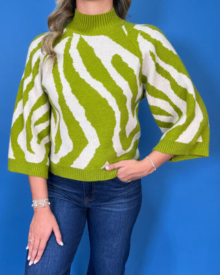 Lime green and ivory zebra print sweater with mock neckline, three-quarter sleeves, and relaxed fit.