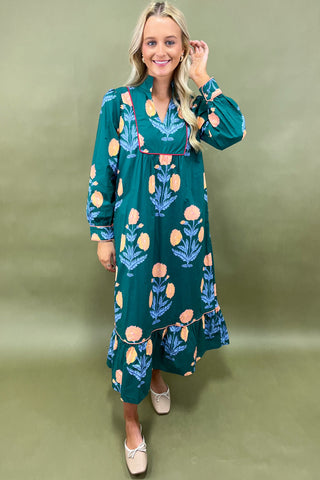 Woman wearing a green floral dress against a green background
