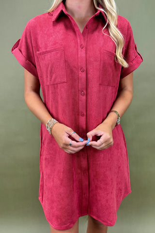 Person wearing a red dress against a green background