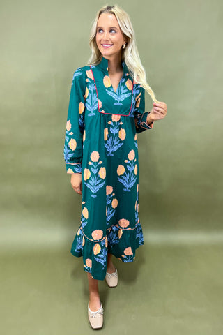 Woman wearing a floral dress against a green background