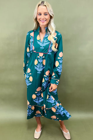 Woman wearing a green floral dress against a green background