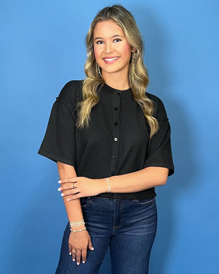 Black button-front short sleeve knit cardigan top with a crew neckline, relaxed fit, and cropped length.