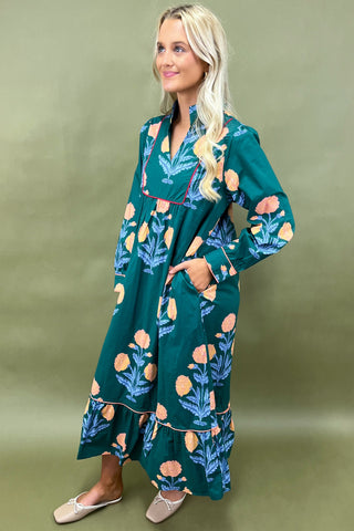 Woman wearing a green floral dress against a green background