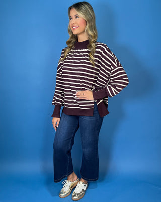Burgundy and ivory striped oversized pullover top with long sleeves, ribbed trim, and relaxed fit.