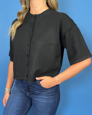Black button-front short sleeve knit cardigan top with a crew neckline, relaxed fit, and cropped length.