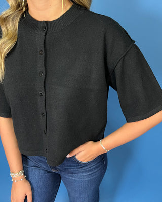 Black button-front short sleeve knit cardigan top with a crew neckline, relaxed fit, and cropped length.