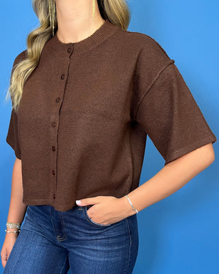 Chocolate brown button-front short sleeve knit cardigan top with a crew neckline, relaxed fit, and cropped length.