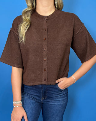 Chocolate brown button-front short sleeve knit cardigan top with a crew neckline, relaxed fit, and cropped length.