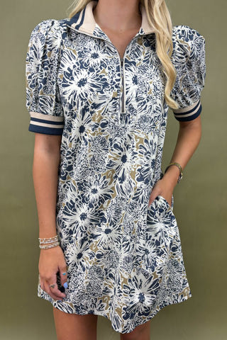 Woman wearing a floral dress with a neutral background