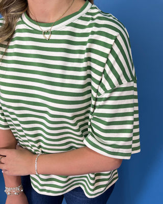 Green and ivory striped oversized top with short sleeves, round neckline, relaxed fit, and casual everyday style.
