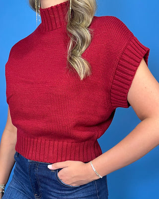 Burgundy mock neck sleeveless knit sweater top with cap sleeves, ribbed trim, and a relaxed fit.